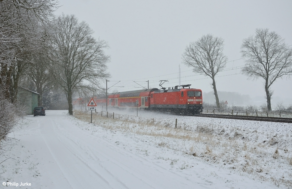112 154-0 mit dem RE 21014 (Hamburg Hbf - Kiel Hbf) am 24.01.2015 bei Wulfsmoor.
